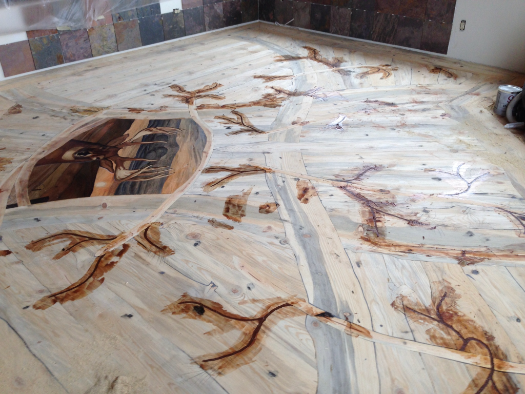 Staining a custom hardwood art floor. 