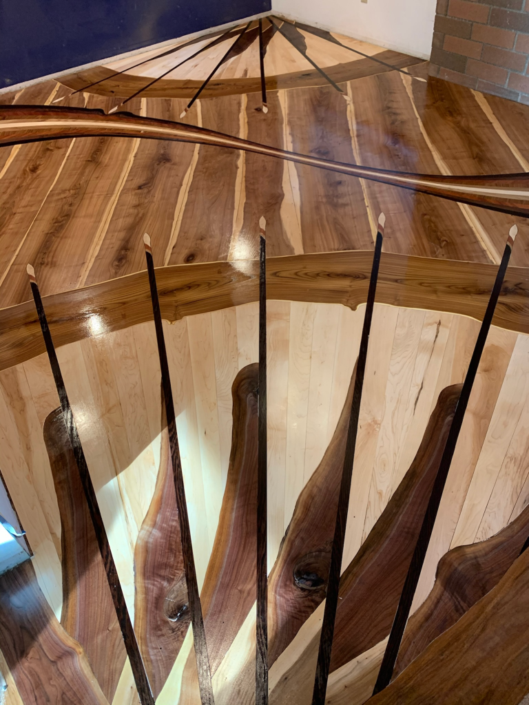 A picture of a custom hardwood art floor called Seattle Swoosh. 