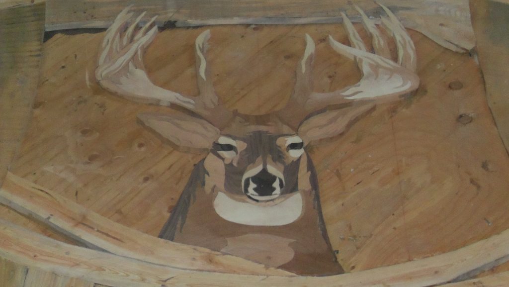 A buck built into a custom hardwood floor in North Idaho. 