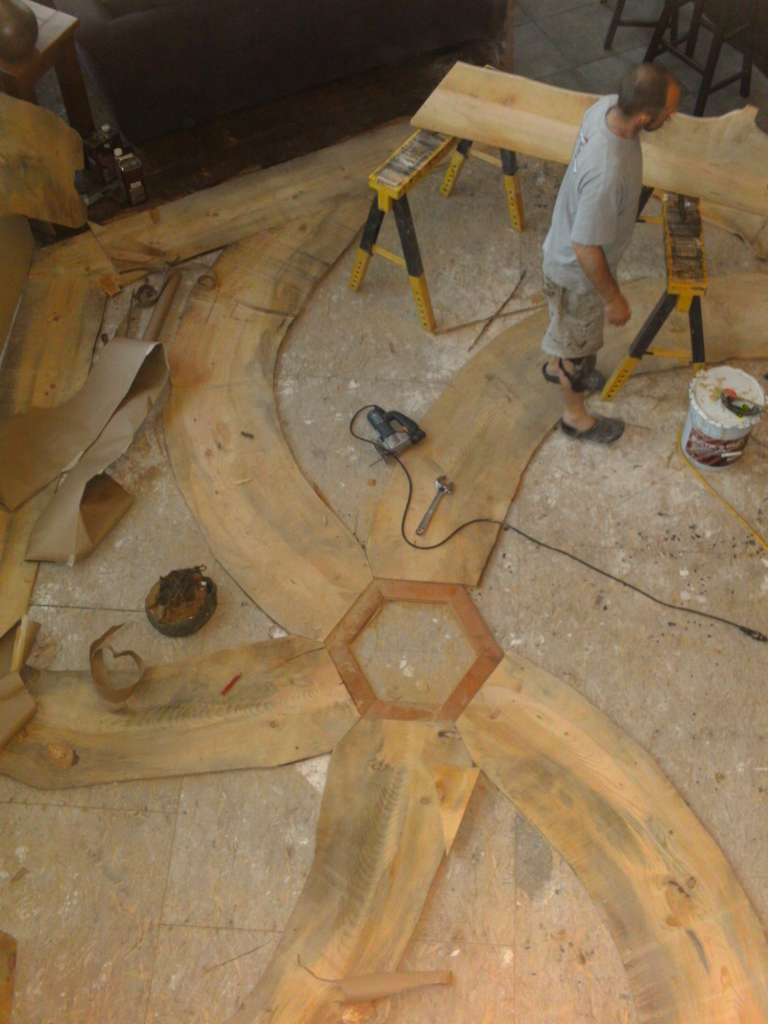 Installing the Blue Pine Swirl custom hardwood floor. 