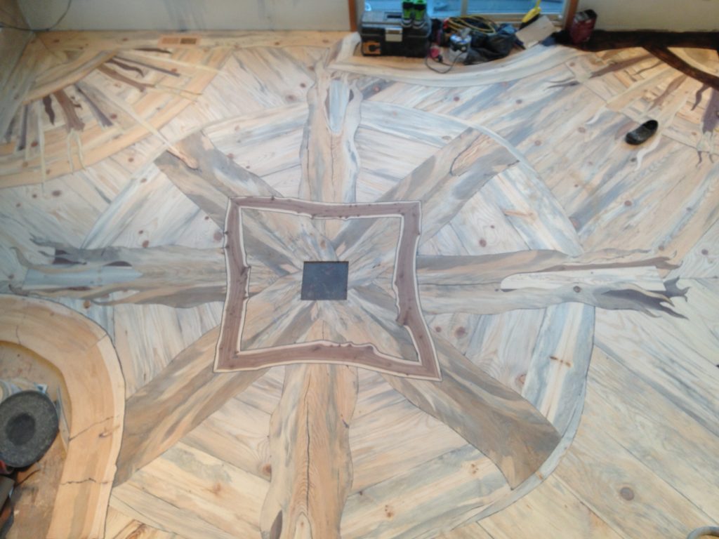 The installation of the Sun Dog hardwood floor project