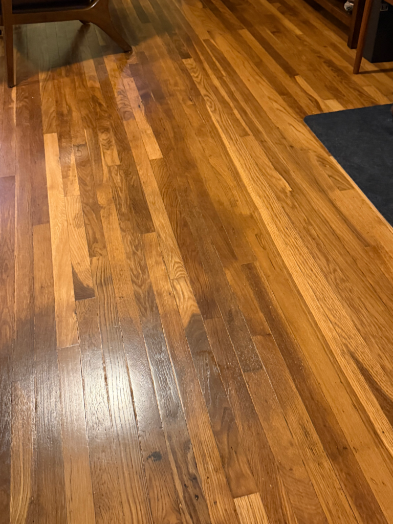 A picture of a squeaky wood floor that has been repaired. 